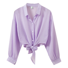 Purple cardigan with thin sun proof top and chiffon lined women's shawl outside summer sand